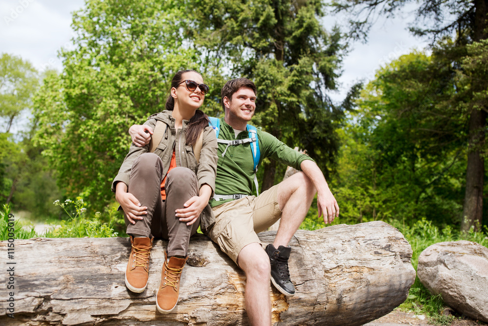 Wunschmotiv: smiling couple with backpacks in nature #115005019