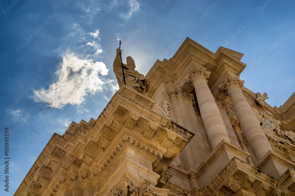 The statue of St. Peter and some baroque elements in the externa