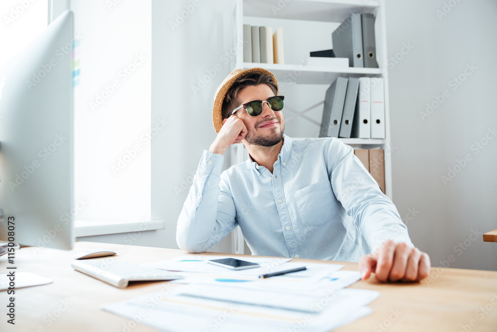 Young happy handsome man sitting at the table Young happy handsome man sitting at the table