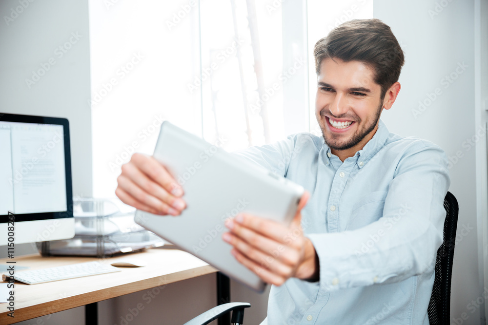 Handsome happy businessman with electronic tablet Handsome happy businessman with electronic tablet