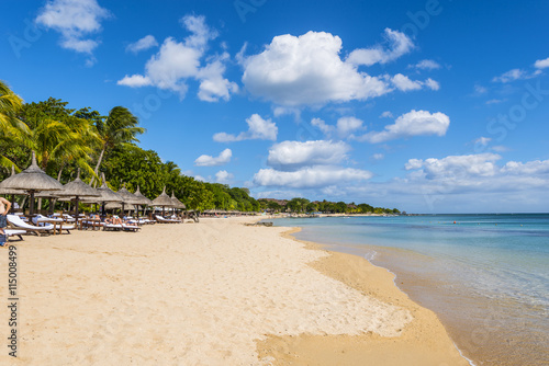 Fototapeta Naklejka Na Ścianę i Meble -  Mauritius beach umbrellas, thatch. Tropical Mauritius island water & beach resort, Turtle Bay - Balaclava