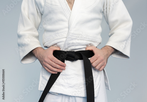 Martial arts Master with black belt in white kimono