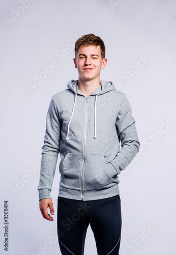 Boy in gray sweatshirt, young man, studio shot © Halfpoint
