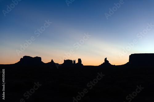 famous silhouette of sandstone in monument valley, sunrise