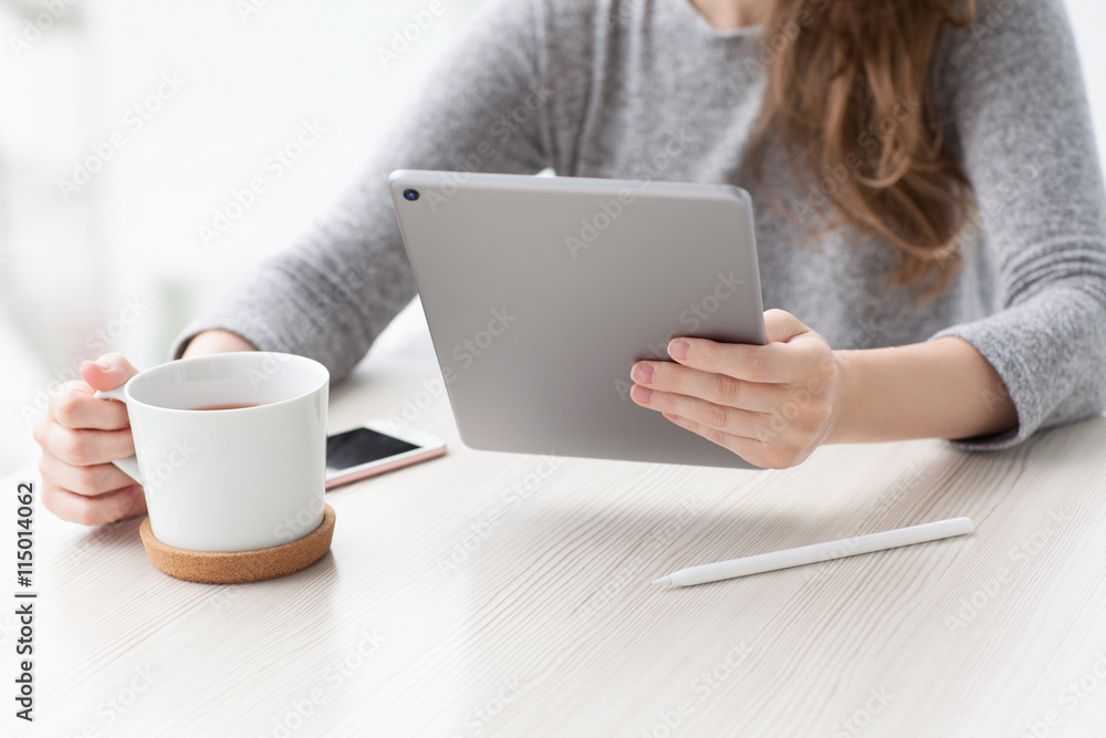woman sitting in summer cafe drinks tea holding tablet computer woman sitting in summer cafe drinks tea holding tablet computer