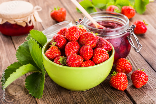 Strawberry on wood background. Strawberry with green leaves.