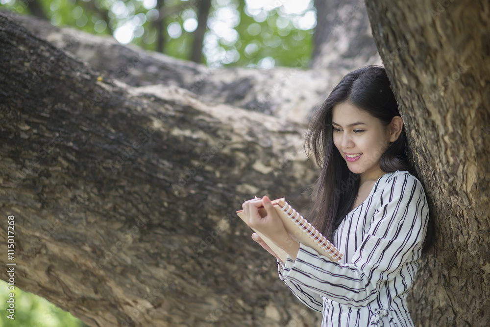 Attractive woman reading a book in the park Attractive woman reading a book in the park