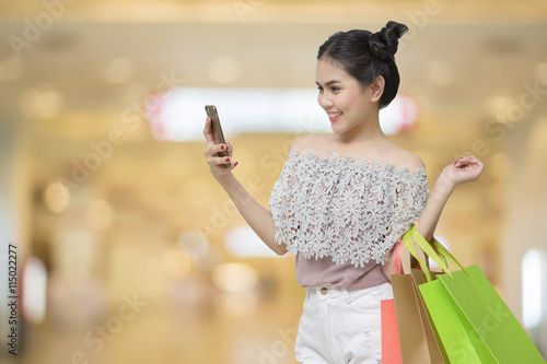 Attractive shopper woman holding shopping bags