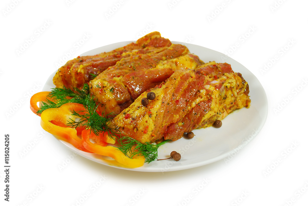 Raw meat. Pork slices with sause and fresh pepper in a Dish Isolated Against White Background Raw meat. Pork slices with sause and fresh pepper in a Dish Isolated Against White Background