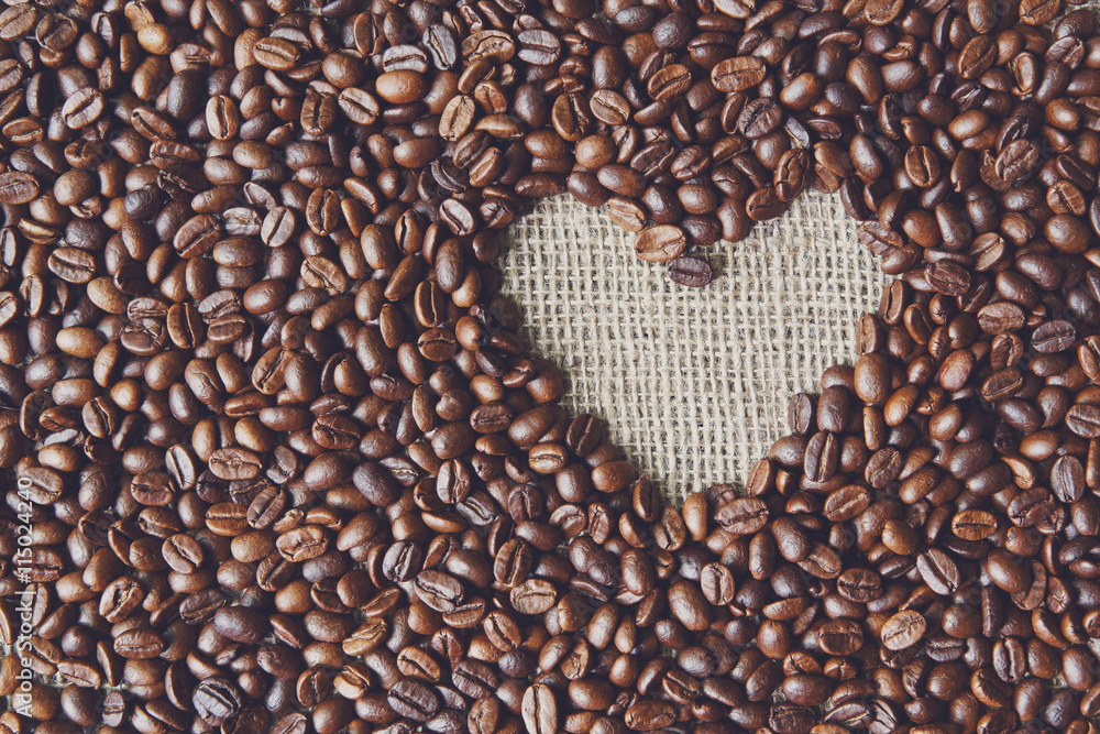 Coffee beans background with burlap heart frame Coffee beans background with burlap heart frame