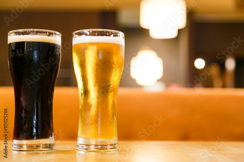 Two glasses of fresh cold beer. A glass  dark , the other light. photo