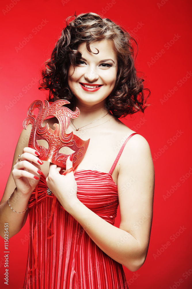 young woman with a red mysterious mask young woman with a red mysterious mask