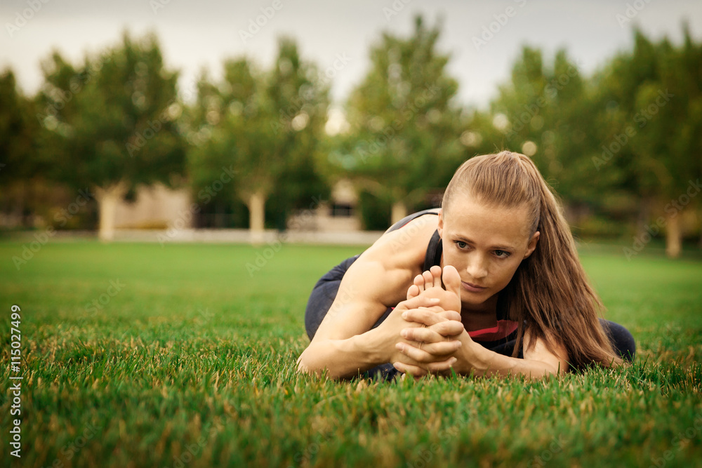 Pretty woman doing yoga exercises in the park Pretty woman doing yoga exercises in the park