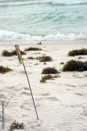 Bottle rocket stuck in the beach sand
