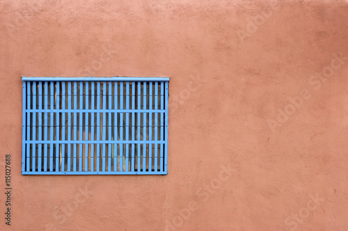 Blue window covering on an adobe building