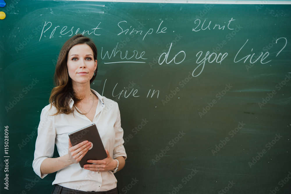 Young Happy Female Teacher With Digital Tablet In Classroom. Young Happy Female Teacher With Digital Tablet In Classroom.