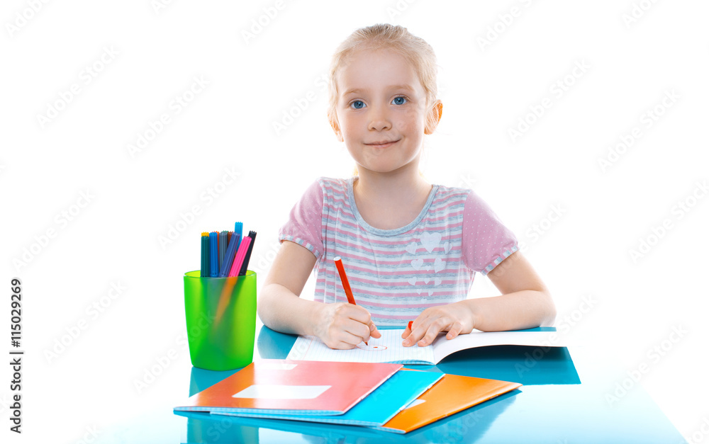 Beautiful young girl drawing with markers. Children's creativity. School assignment Beautiful young girl drawing with markers. Children's creativity. School assignment