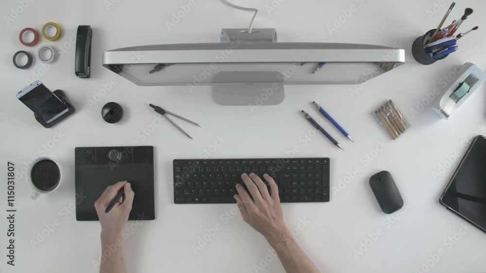 top view man architect 3D designer uses his pen tablet with his computer top view man architect 3D designer uses his pen tablet with his computer