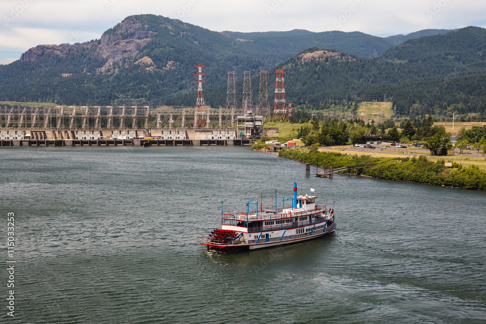 Touristic boat visiting an Industrial Water Dam on Columbia River, Oregon.