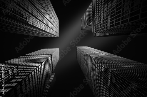 Architectural fine-art black and white photograph with four New York skyscrapers converging towards the sky