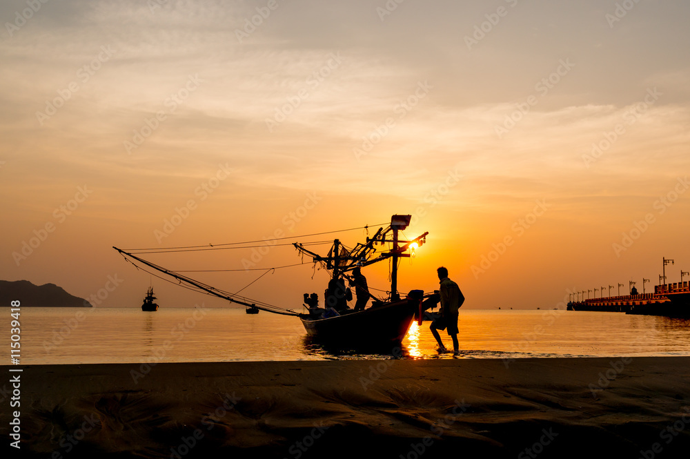 Silhouettes of fishing boats and fishermen at sunrise. Silhouettes of fishing boats and fishermen at sunrise.