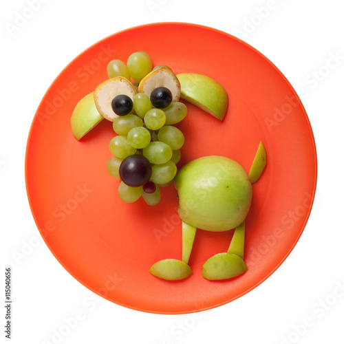 Confused dog made of green apple on orange plate