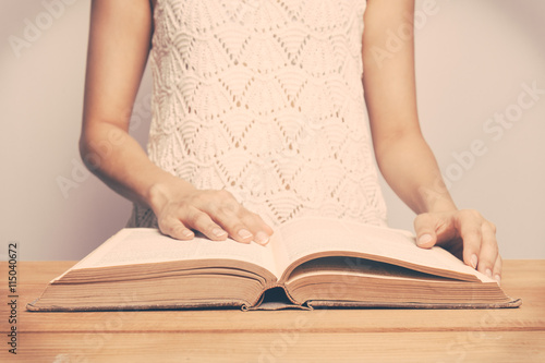 Vintage tone of A close-up of a christian woman reading the bibl