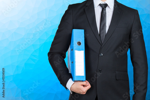 Confident businessman holding a document folder photo