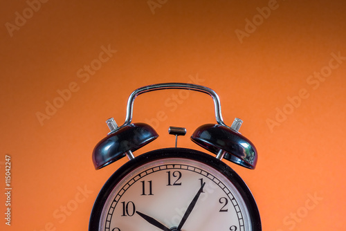 Retro alarm clock on colour background with copy space