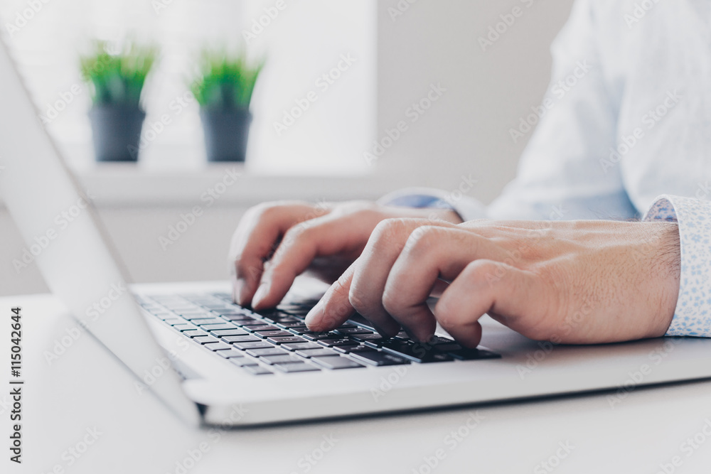 Businessman at work. Close-up top view of man working on laptop Businessman at work. Close-up top view of man working on laptop