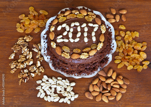 New Year 2017 homemade cake decorated with nuts and raisins on a cutting board