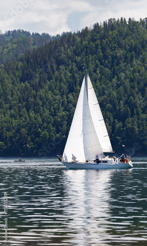 Single-masted sailing yacht in the source of the Angara River