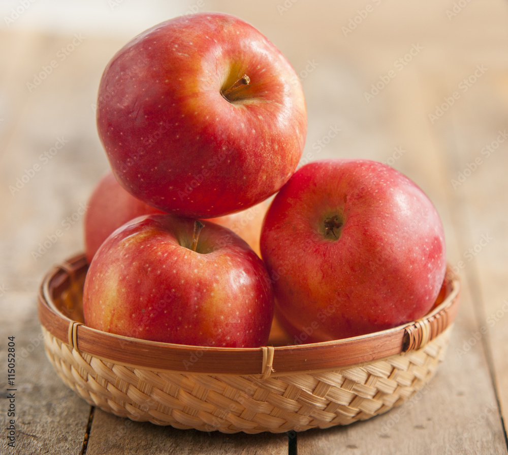 Fresh harvest of apples. Nature theme with red grapes and basket on wooden background. Nature fruit concept. Fresh harvest of apples. Nature theme with red grapes and basket on wooden background. Nature fruit concept.