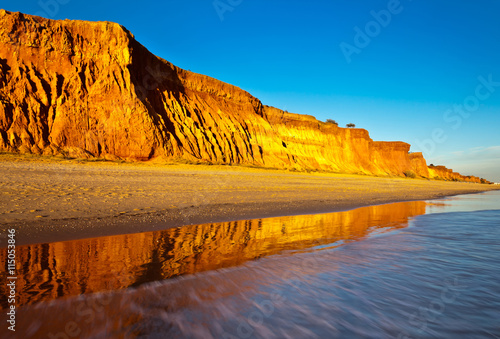 Portugal. Algarve. Falesia sandy beach and cliffs at sunset. Bright seascape photo