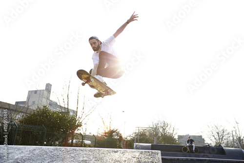 Young man jumping on skateboard