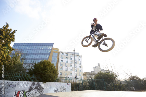 Young man jumping on bmx bicycle