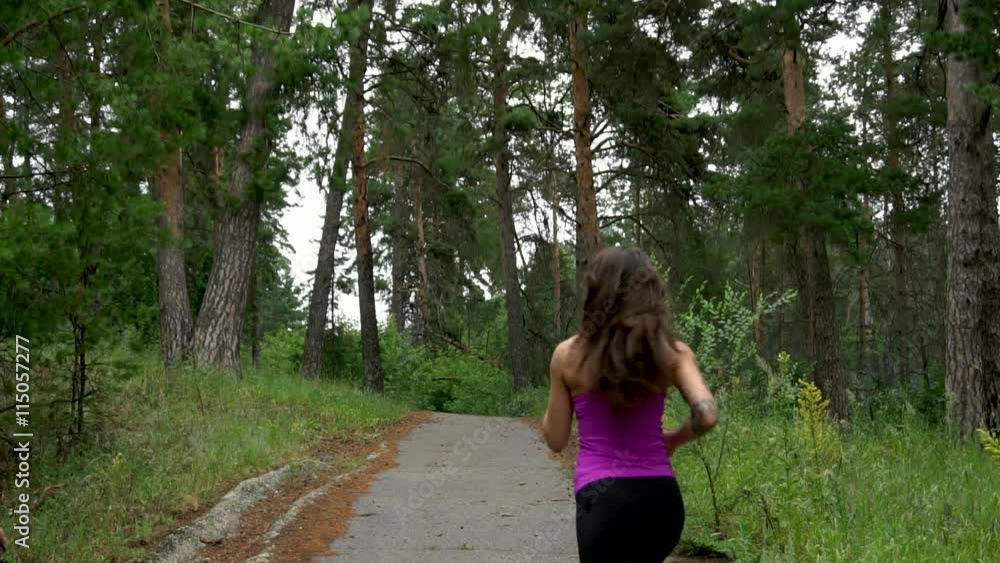 Sporty girl runs through the park in the morning. Slow motion. Full HD Sporty girl runs through the park in the morning. Slow motion. Full HD