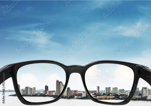 Glasses with city and sky background