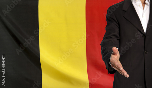 Open hand and Belgium flag in the background