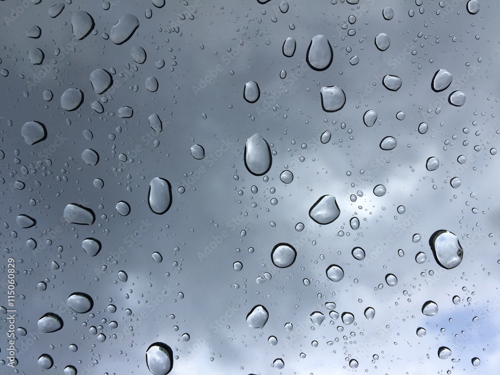 drops of rain on car glass with dark clouds - background drops of rain on car glass with dark clouds - background