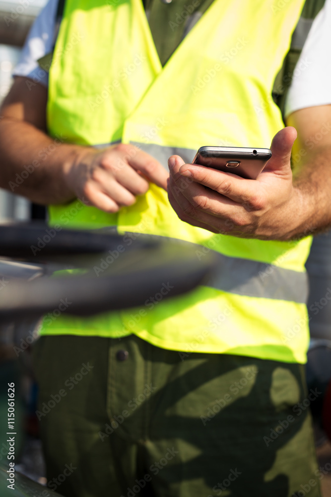 Oil worker using smart phone