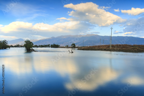 Sunset over one of the many lakes in the village of Heqing in Yunnan, China photo