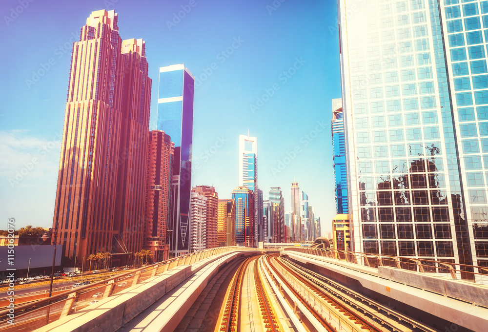 Modern architecture of Dubai UAE, seen from a metro car. Scenic view of the Dubai skyscrapers. Travel background.