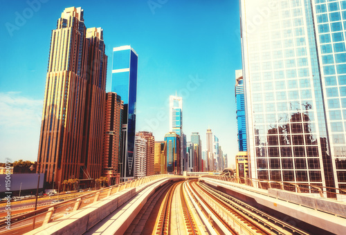 Modern architecture of Dubai UAE, seen from a metro car. Scenic view of the Dubai skyscrapers. Travel background.