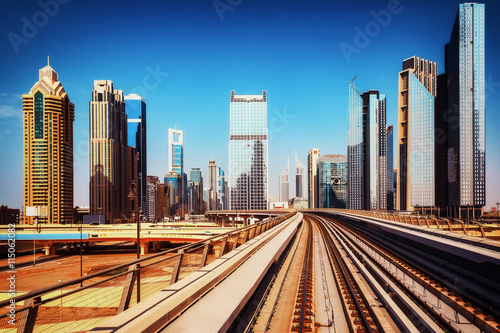 Modern architecture of Dubai, UAE, seen from a metro car. Scenic view of the Dubai skyscrapers. Travel background.