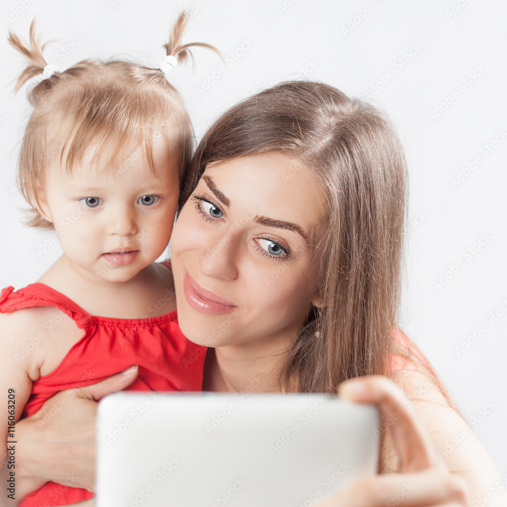 Funny baby and mother make selfie on mobile phone Funny baby and mother make selfie on mobile phone