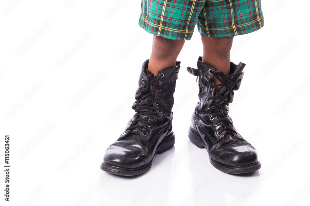 little boy  wearing big shoe