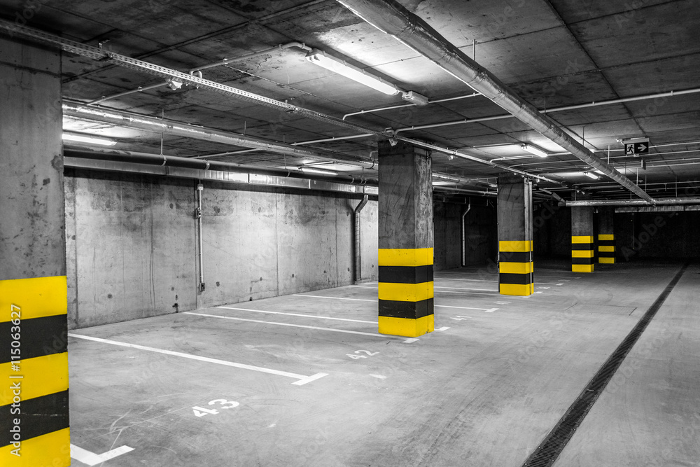 Mysterious black and white underground garage with yellow details Stock
