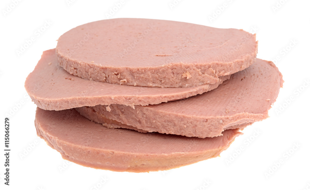 Slices of chicken bologna stacked on a white background. Slices of chicken bologna stacked on a white background.