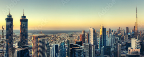 Scenic panoramic view of Dubai modern architecture at sunset. Aerial skyline with downtown skyscrapers.